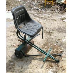 Roller tractor trailer includes tractor seat