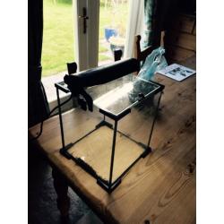 Aquel small tropical fish tank with lamp and black gravel