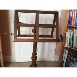 Early Victorian music stand in wood with candle holders. Possibly oak. Extendable to 6ft. [183cm]