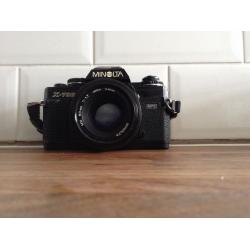 Minolta camera with flash and zoom lense.
