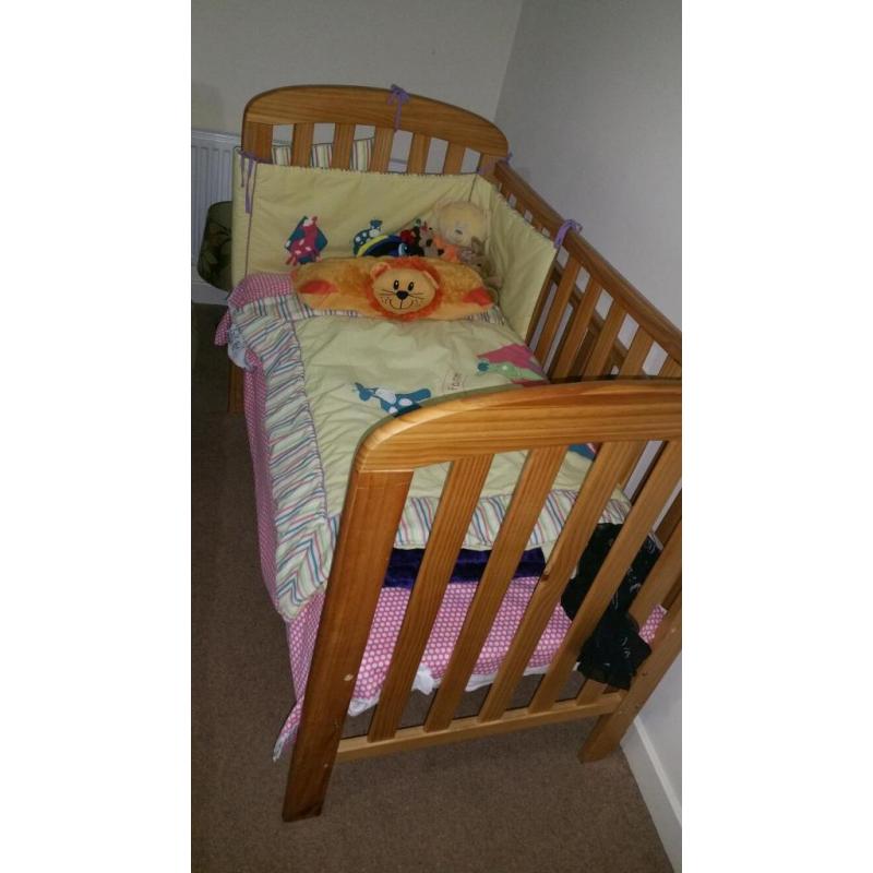 Baby cot. Wood. Drop down side. With matteress and bedding.