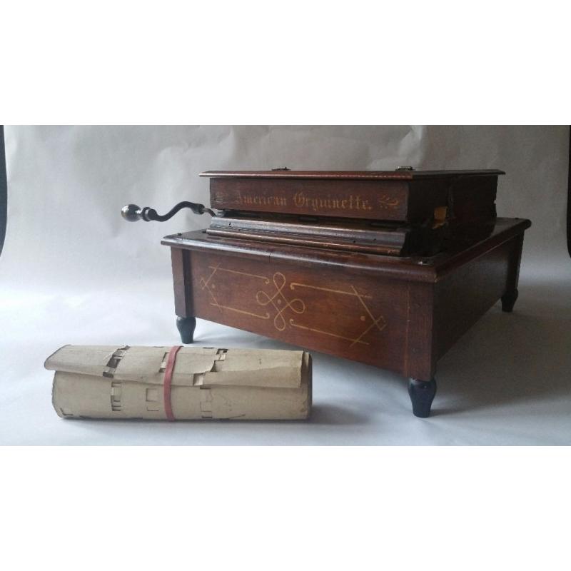 ORGAN. Hand crank roll organ with 25 rolls of music.