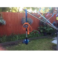 Electric grass strimmer.