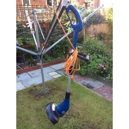 Electric grass strimmer.