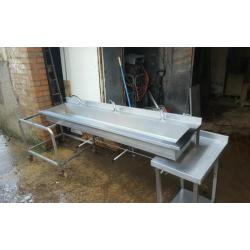 Stainless steel knee operated sink.