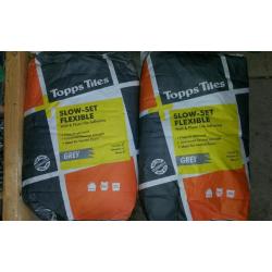 2x Slow -set flexible adhesive grey.