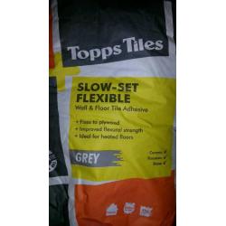 2x Slow -set flexible adhesive grey.
