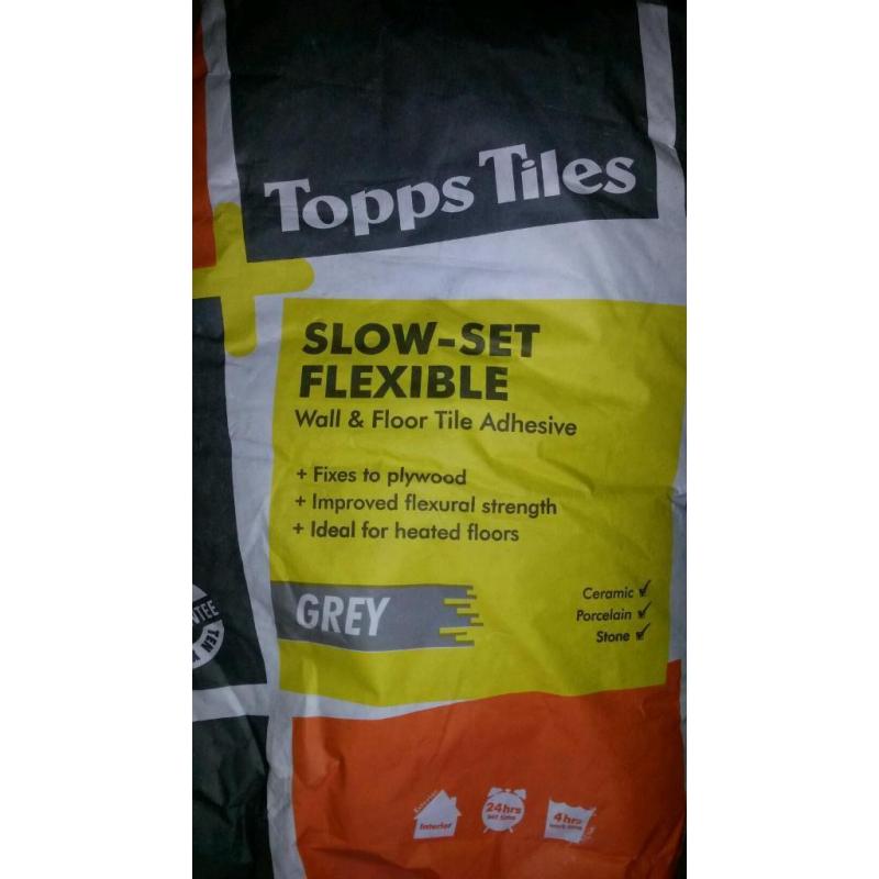 2x Slow -set flexible adhesive grey.