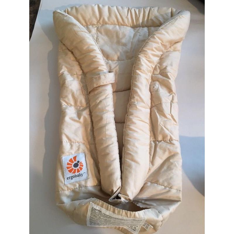 Ergo baby carrier and snug infant insert.
