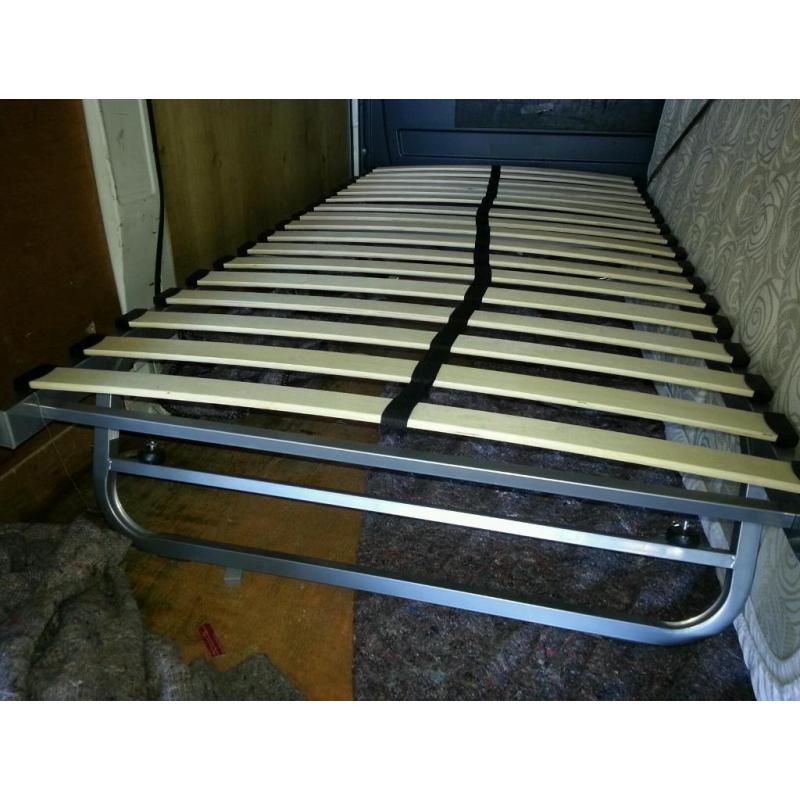 Slide under bed frame/guest bed.
