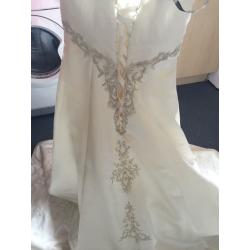 Wedding dress size 10 lovely dress never worn few marks due to storage just needs dry cleaned