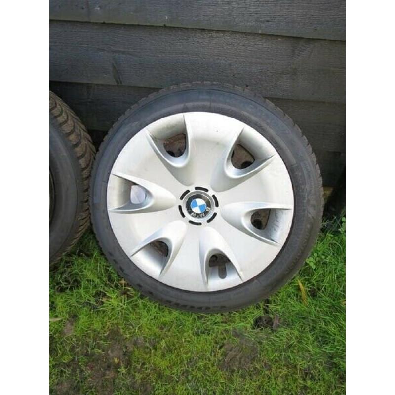 4 Goodyear Ultragrip winter tyres on steel wheels with covers for BMW series 1