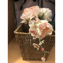 White vase with flowers and basket