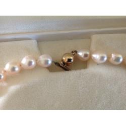 String of Cream Baroque Pearls individually knotted with 9ct Gold Clasp one owner from new